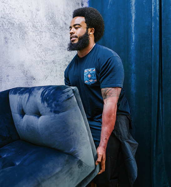 Man moving a sofa bed